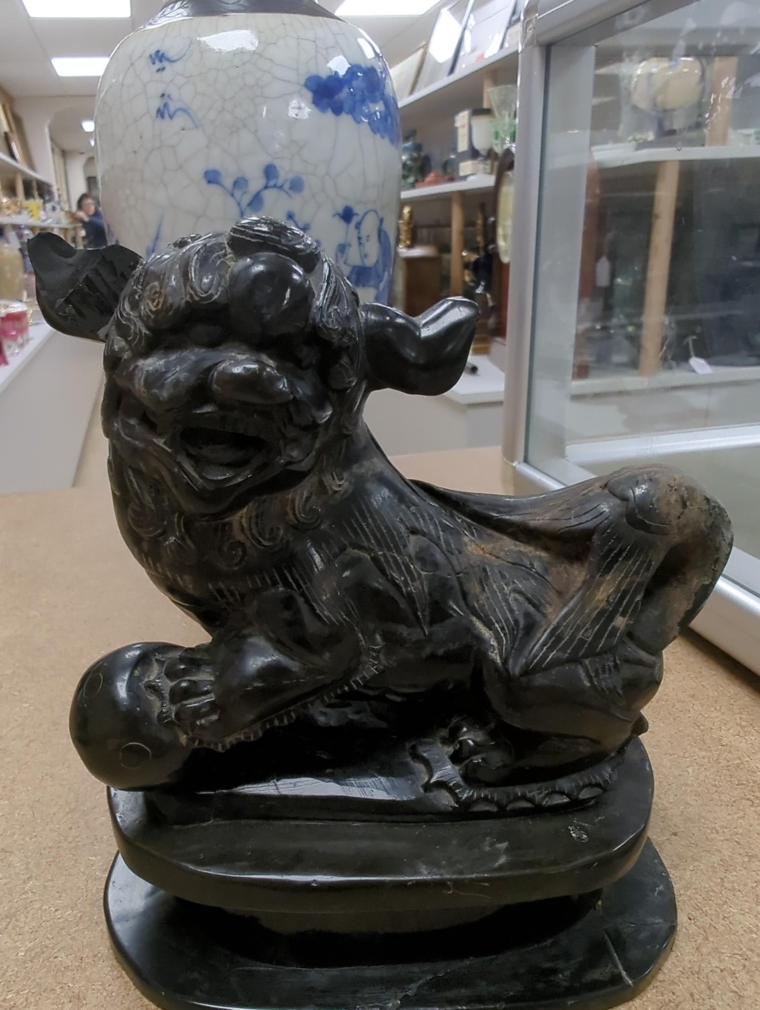 Three Chinese blue and white crackle glaze vases, a famille rose brush pot, late 19th/early 20th century, a crackle glaze ginger jar and a carved soapstone lion-dog (6)